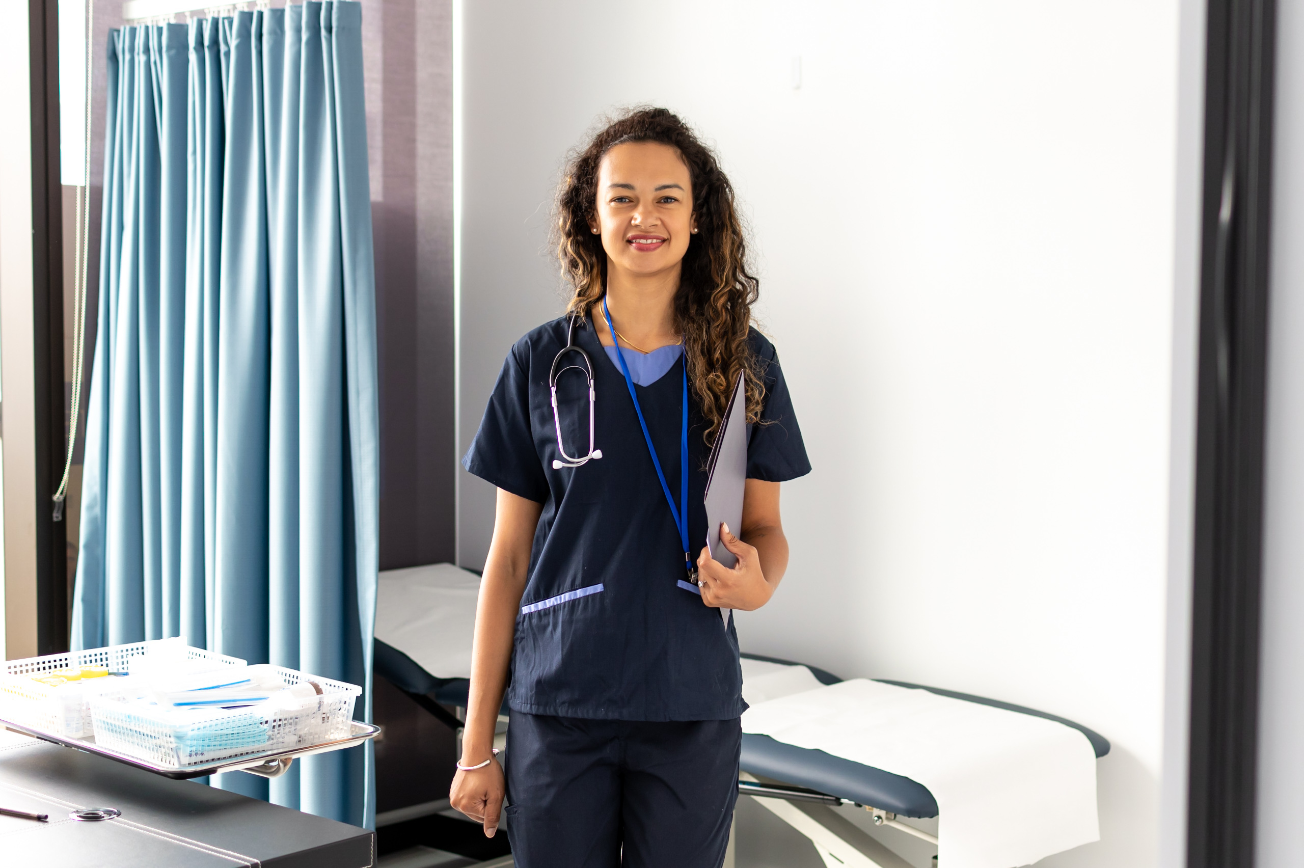 nurse standing in ward holding files