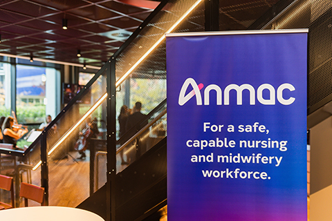 Blue banner with white text reading "Anmac: For a safe, capable nursing and midwifery workforce" beside a modern staircase in an office setting.